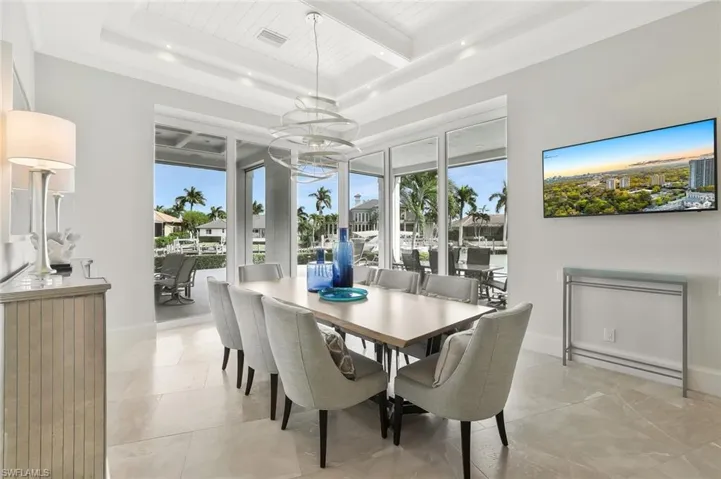 Dining area with plenty of natural light, suspended lighting, and a wood ceiling with exposed beams