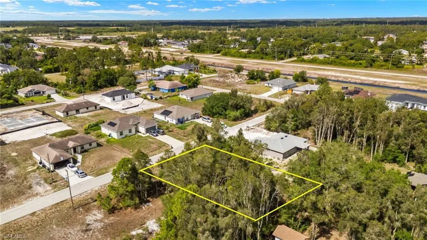 Aerial perspective of suburban area with property parcel outlined