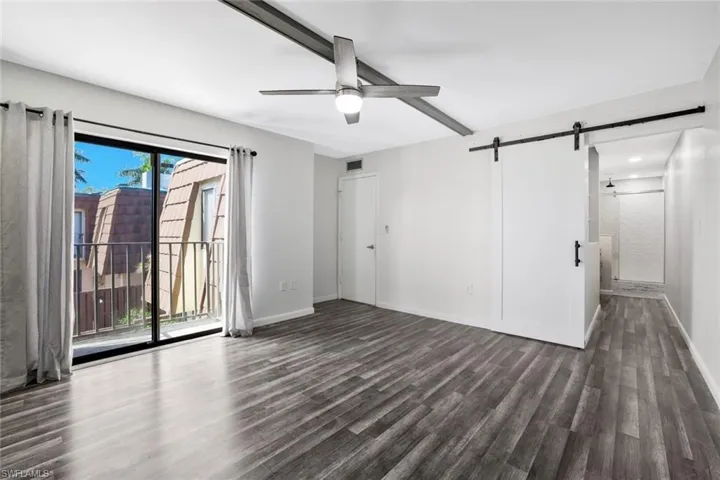 Primary bedroom with barnyard door to bathroom