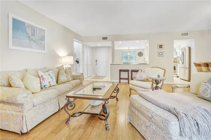 Living room featuring light wood-type flooring and baseboards