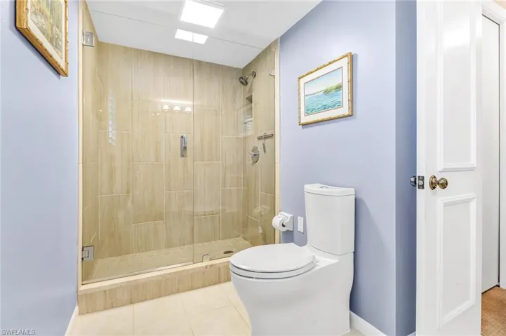 Full bath with a stall shower and light tile patterned floors