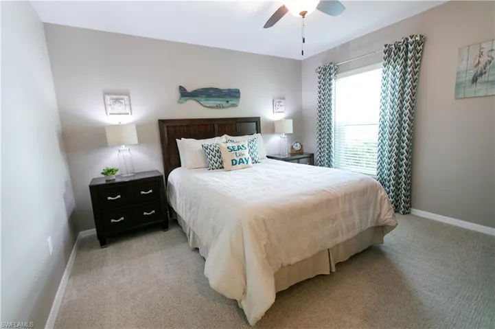 Bedroom featuring light carpet and ceiling fan