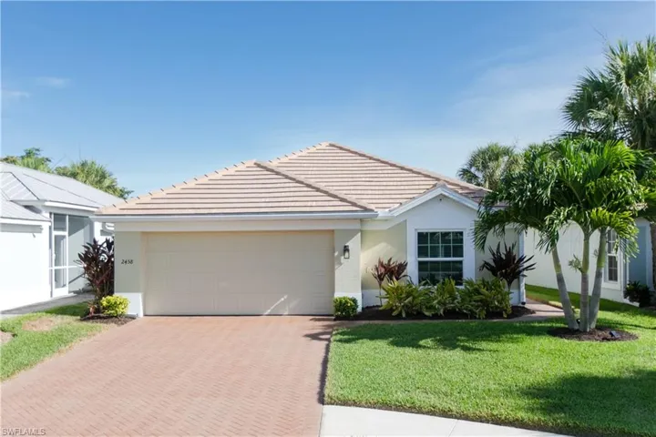 Single story home featuring a front yard and a garage