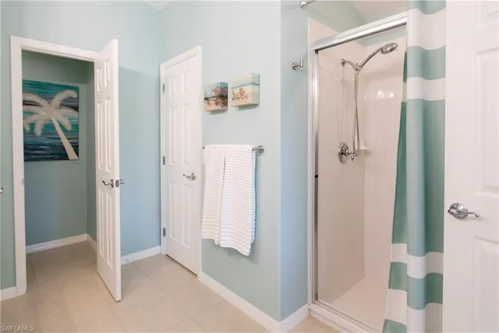 Bathroom with tile flooring and an enclosed shower