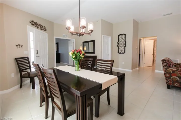 Dining room featuring a chandelier and light tile flooring