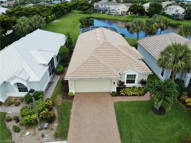 Birds eye view of property with a water view