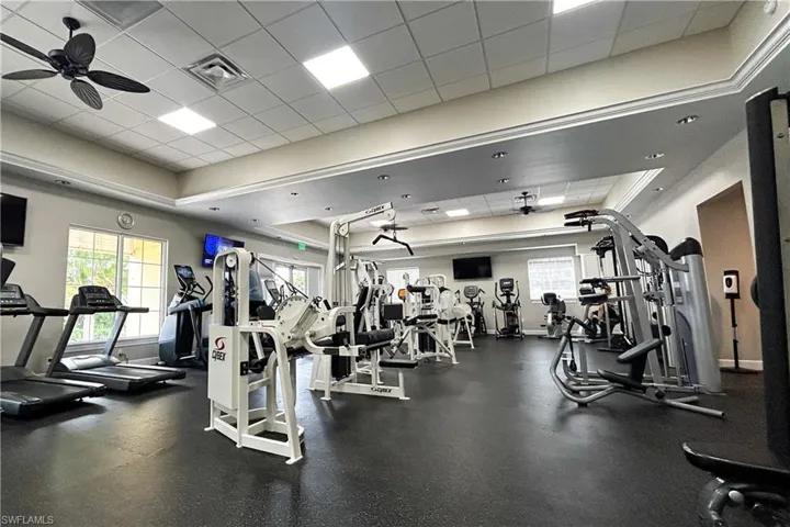 Exercise room featuring a paneled ceiling and ceiling fan