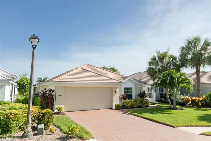 Single story home featuring a front lawn and a garage