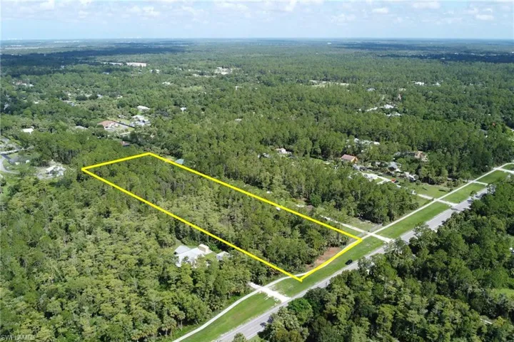 Aerial overview of property's location featuring a heavily wooded area and property parcel outlined