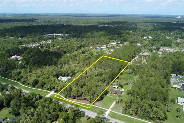 Aerial overview of property's location featuring a forest and property boundaries highlighted