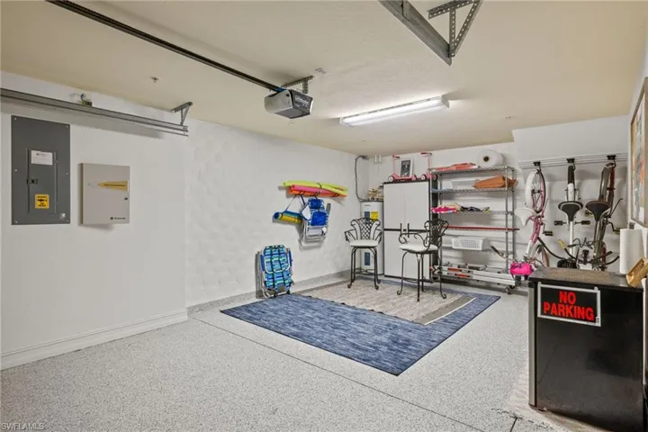 Garage featuring electric panel and a garage door opener