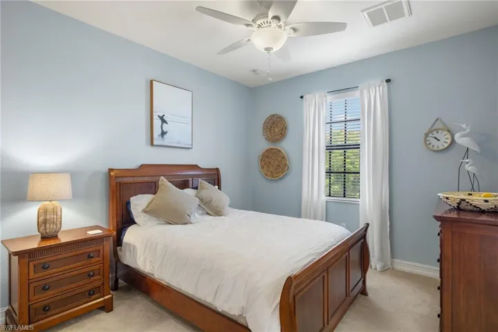 Bedroom featuring light carpet and ceiling fan