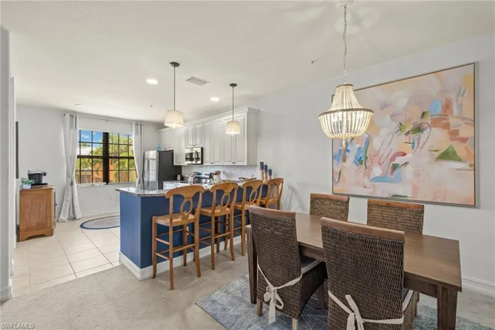 Carpeted dining space with a chandelier