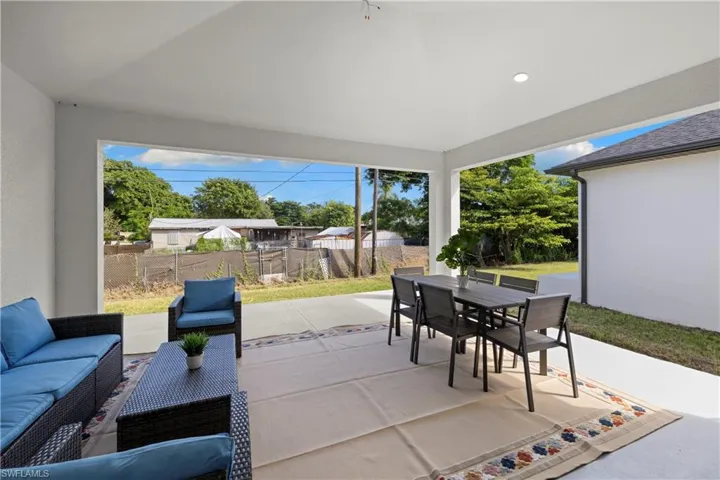 Expansive covered patio featuring a concrete surface, recessed lighting, and a white stucco exterior wall