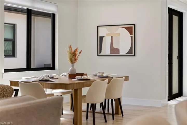 Dining area featuring light wood-finish flooring and a neutral color palette