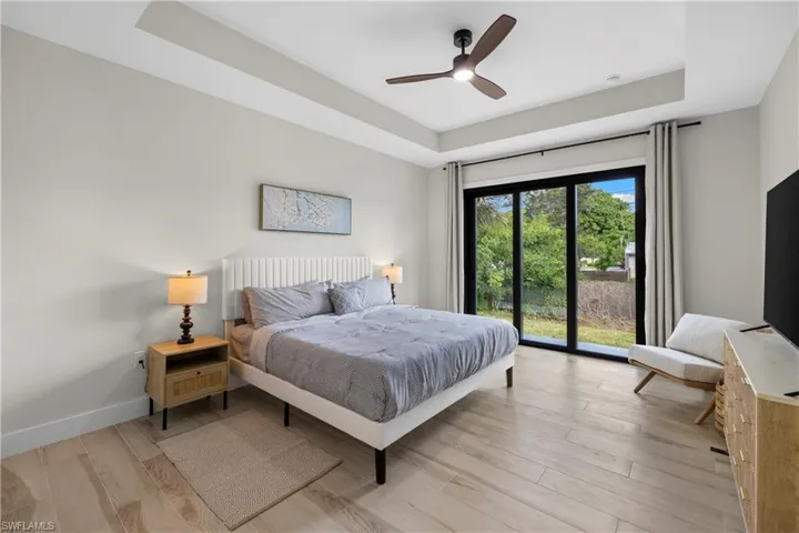 Tray ceiling with recessed lighting and a contemporary ceiling fan