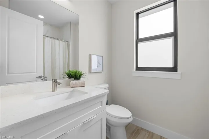 White vanity with an integrated rectangular sink and a single-handle faucet