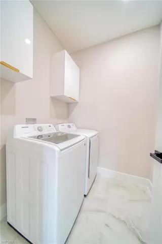 Laundry area with cabinets and independent washer and dryer