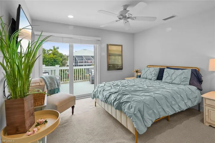 Bedroom with access to outside, carpet flooring, and ceiling fan