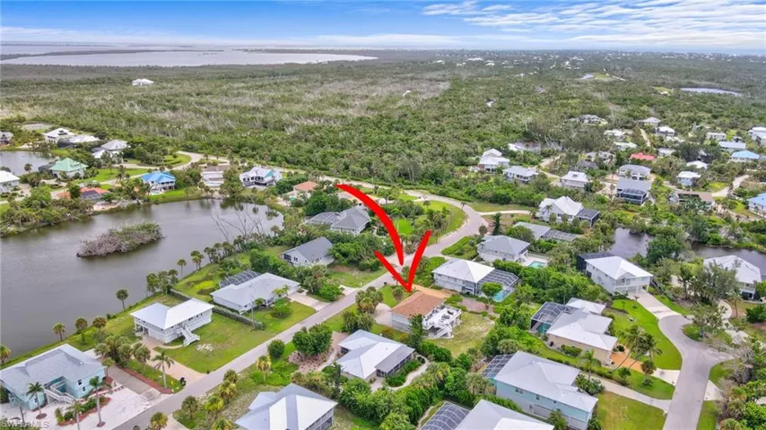 Aerial overview of property's location with nearby suburban area and a large body of water