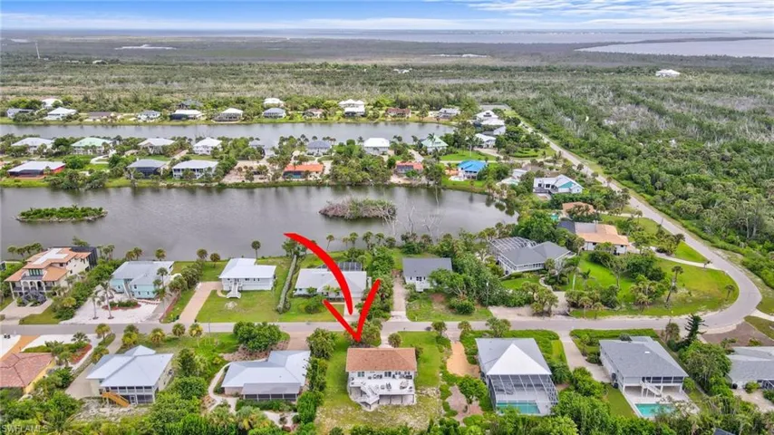 Aerial view of property's location with nearby suburban area