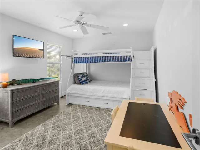 Bedroom with a ceiling fan and recessed lighting