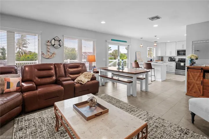 Living room with recessed lighting and light tile patterned flooring