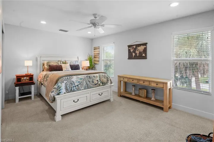 Carpeted bedroom with recessed lighting and a ceiling fan