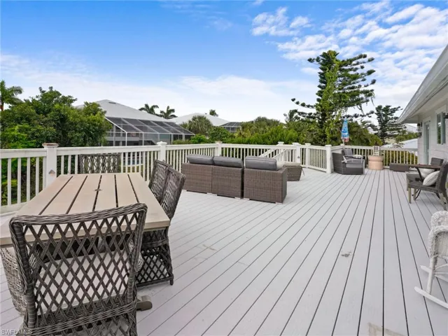 Wooden terrace with outdoor dining area and an outdoor hangout area