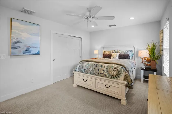Carpeted bedroom with recessed lighting, ceiling fan, and a closet