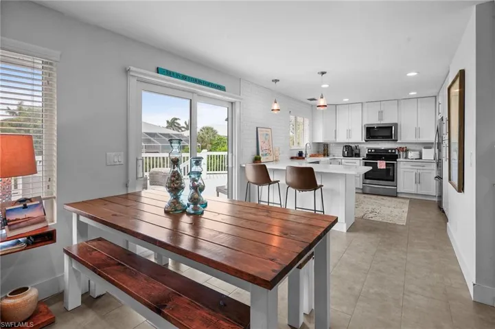 Dining area featuring recessed lighting and light tile patterned flooring