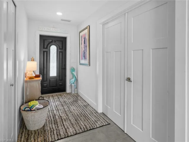 Entrance foyer featuring baseboards and recessed lighting