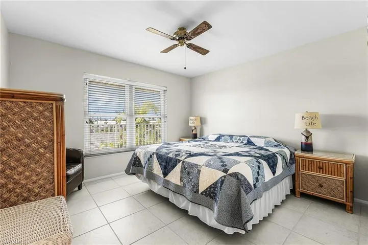 Bedroom featuring light tile floors and ceiling fan