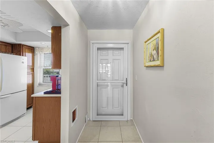 Entryway with tile floor and a textured ceiling