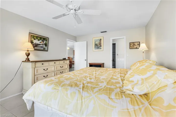 Bedroom featuring light tile patterned floors and a ceiling fan