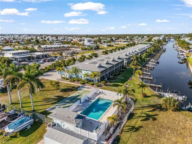 Aerial view of a pool area and a large body of water