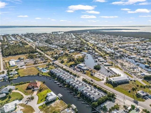 View of property location featuring a nearby body of water and nearby suburban area