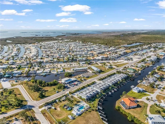 Aerial view of property's location featuring a large body of water and nearby suburban area