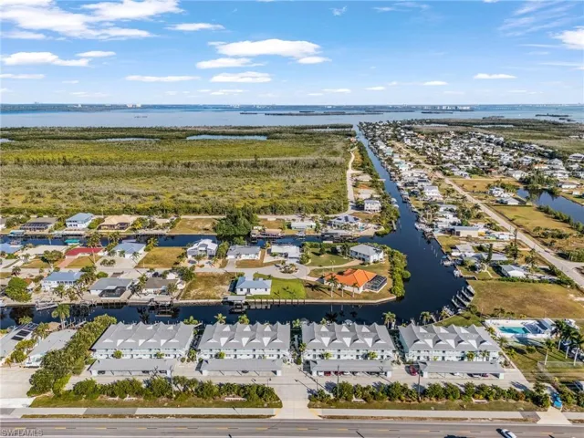 Aerial view of residential area featuring a large body of water