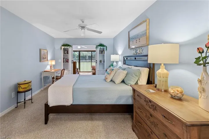 Bedroom featuring access to exterior, a ceiling fan, and light carpet