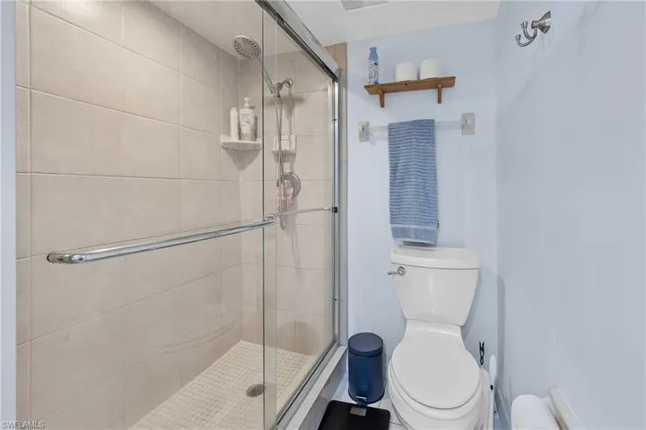 Bathroom featuring toilet and a shower stall