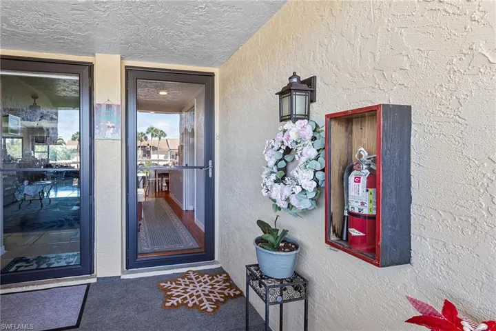 Entrance to property featuring stucco siding