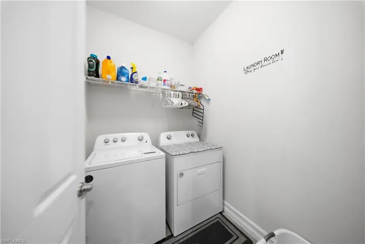 Laundry area featuring independent washer and dryer and baseboards