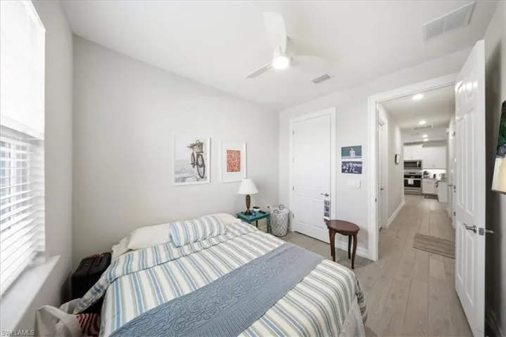 Bedroom with light wood finished floors and a ceiling fan