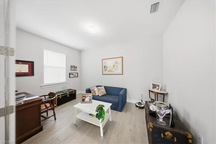 Living room with light wood-style floors and baseboards