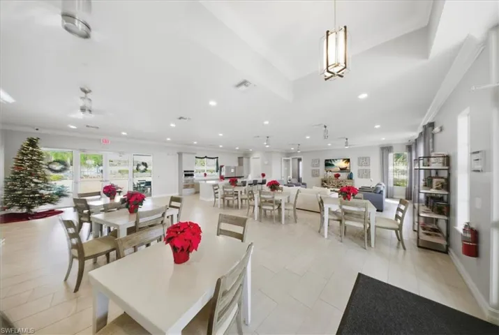 Dining space with plenty of natural light, ornamental molding, and light tile patterned floors