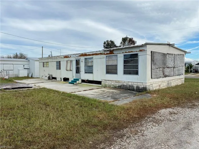 Back of property featuring a yard and a patio