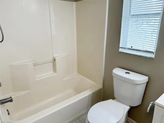 Full bathroom with shower / bathtub combination, toilet, and vanity