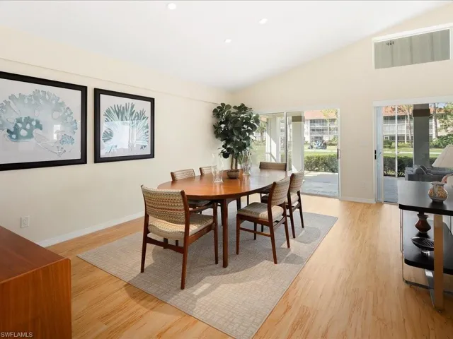 Dining area featuring lofted ceiling and light hardwood / wood-style flooring