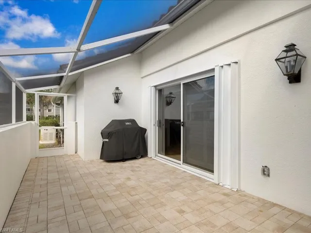 View of patio / terrace with area for grilling and a lanai